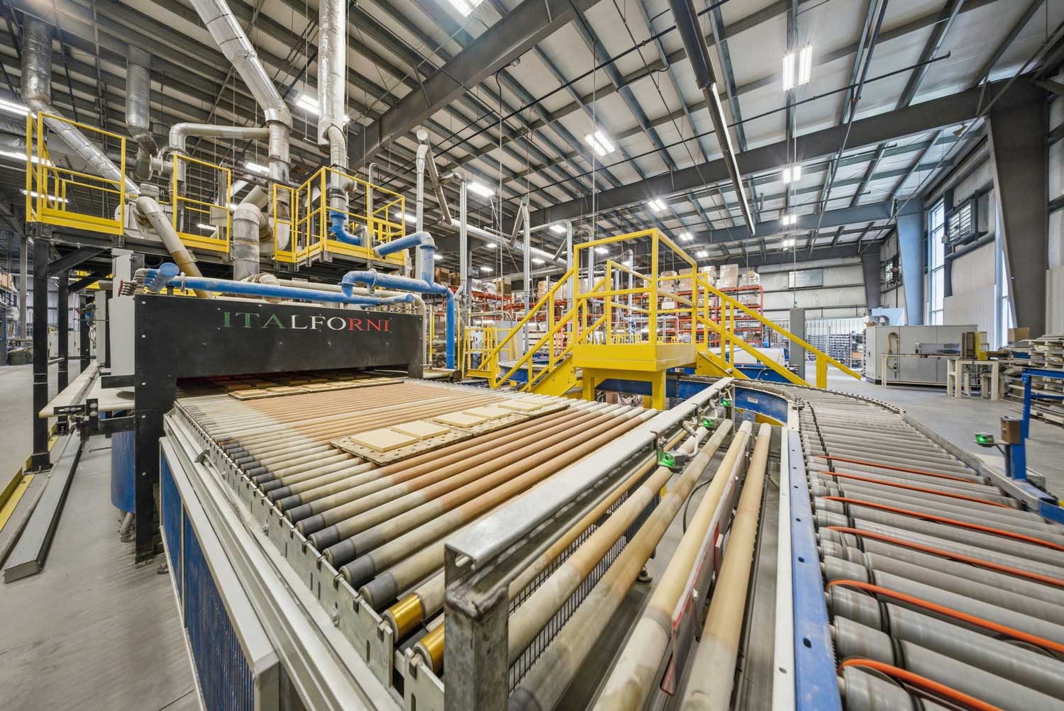 Italforni continuous roller kiln with ceramic components moving through the firing line.